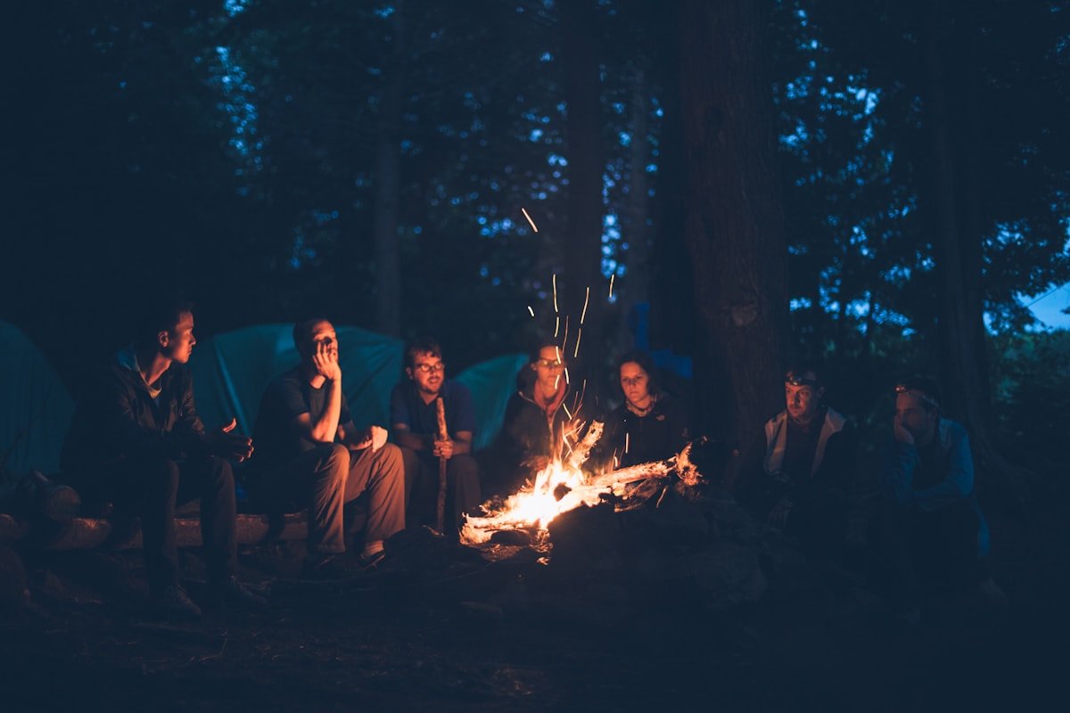 Friends gathered around a campfire