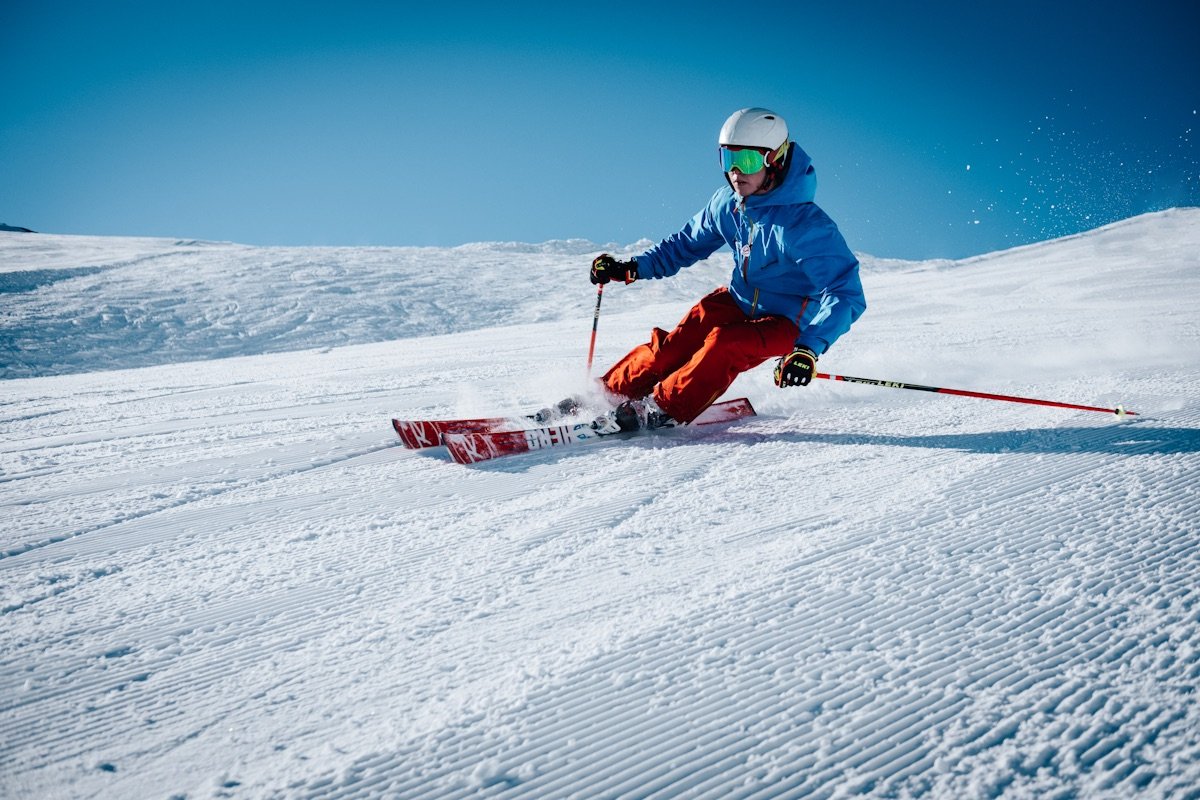 Skier descending a bright mountain slope