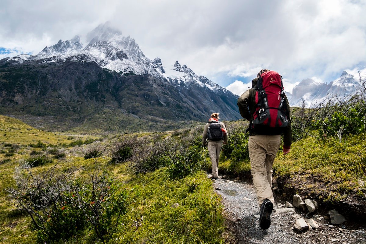 Hikers carrying backpacks on a mountain trail